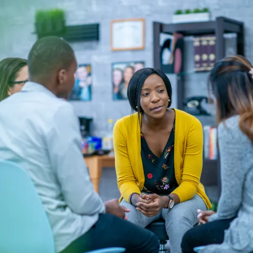 Group of adults talking while seated in a circle.