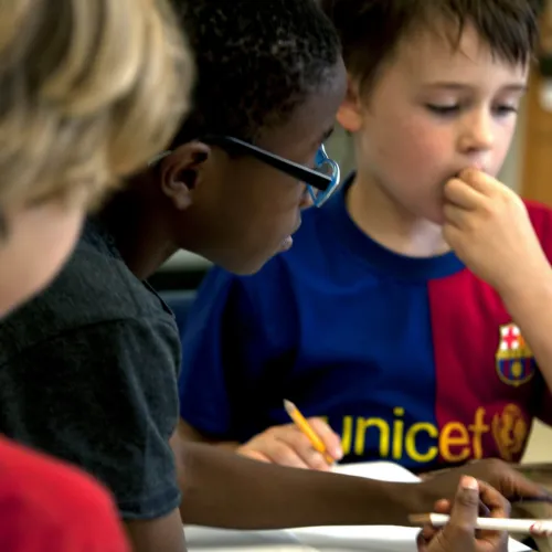 3 Primary school age boys working together in classroom setting