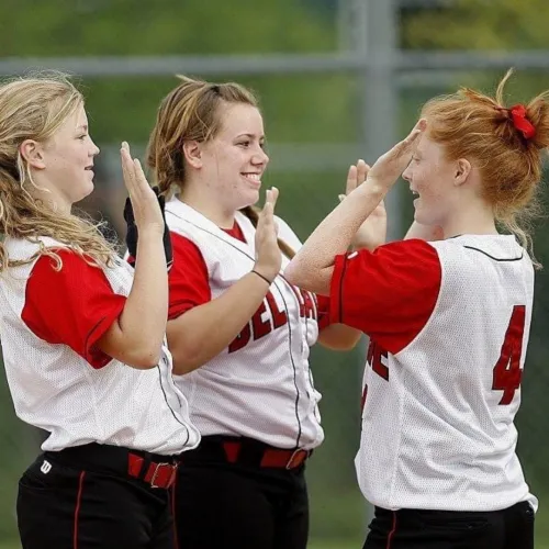 Group of young sportswomen  high-fiving