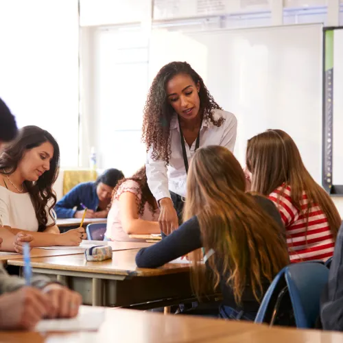 Teacher and group of young women in a clasroom setting