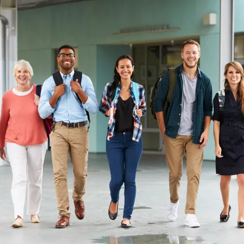 Ethnically diverse group of 5 men and women walking towards the camera