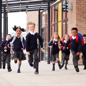 Picture of a group of primary school children running towards the camera